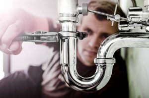 plumber-working-on-sink-pipe