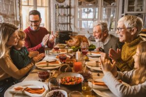 family-gathered-around-kitchen-table-for-holiday-meal
