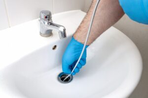 plumbers-hand-using-drain-snake